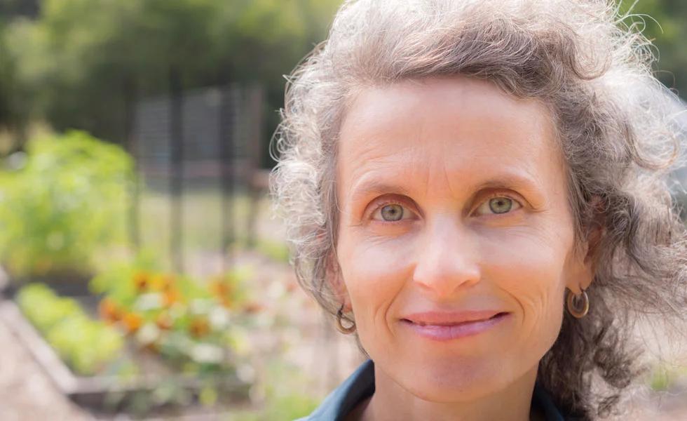 A woman in her 60s looks at the camera with a slight smile